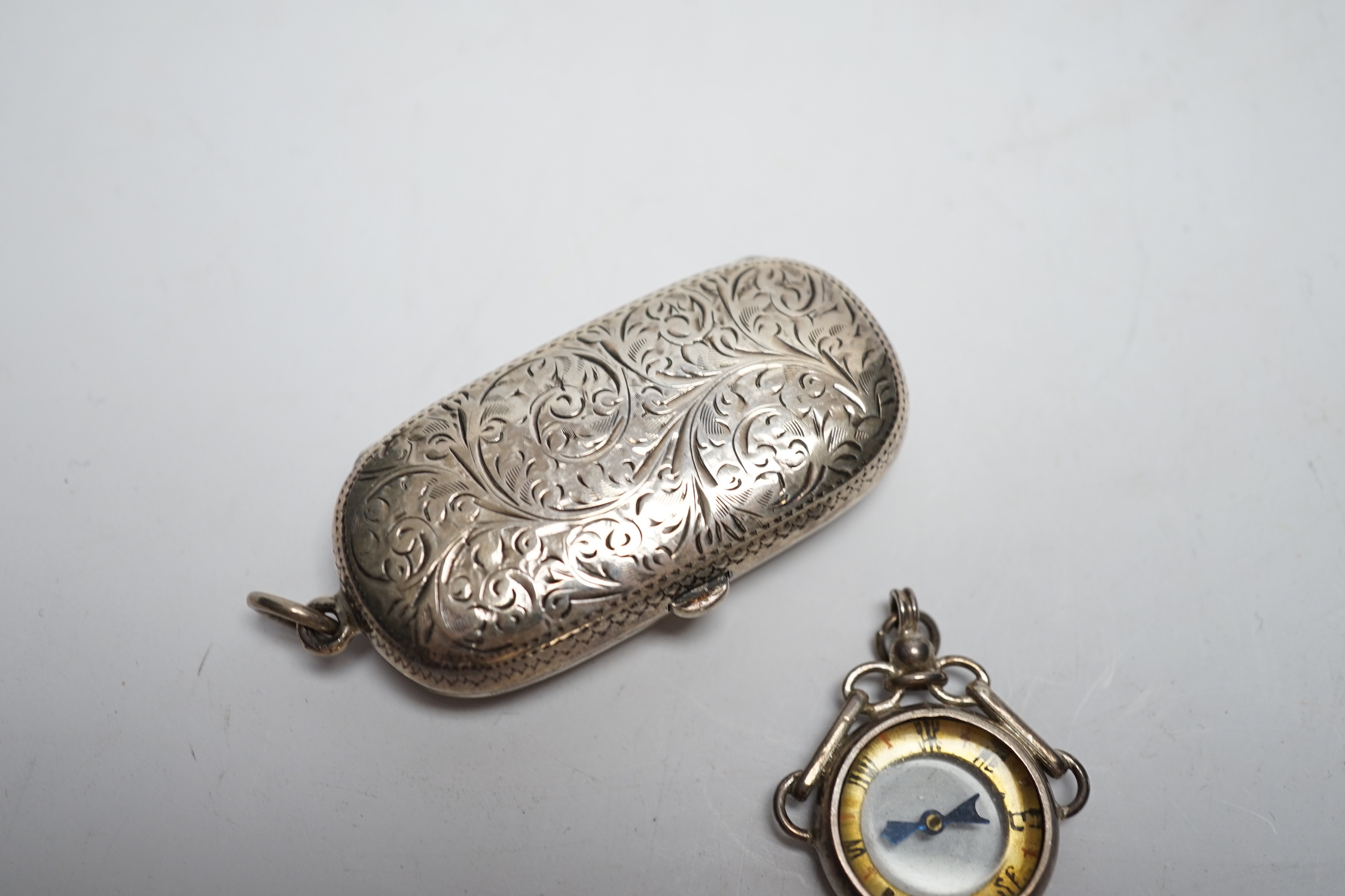 A late Victorian silver twin sovereign case, Chester, 1899 and a George V silver mounted compass fob.